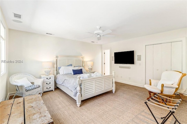 bedroom with ceiling fan and a closet