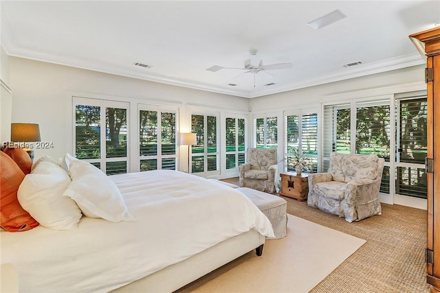 bedroom featuring ceiling fan, ornamental molding, and light colored carpet