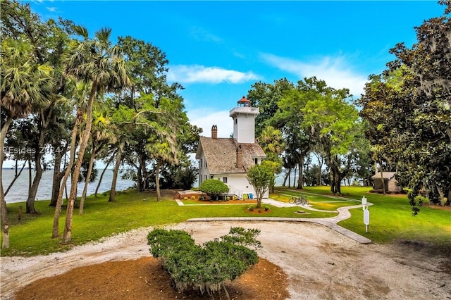 exterior space featuring a yard and a water view