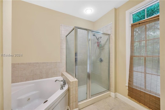 bathroom with independent shower and bath and tile patterned floors