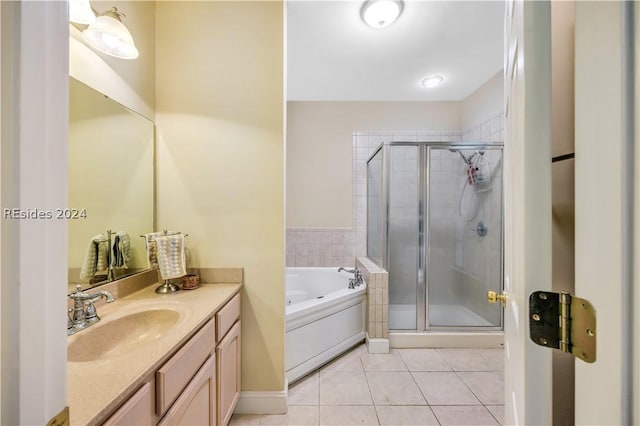 bathroom featuring vanity, independent shower and bath, and tile patterned flooring