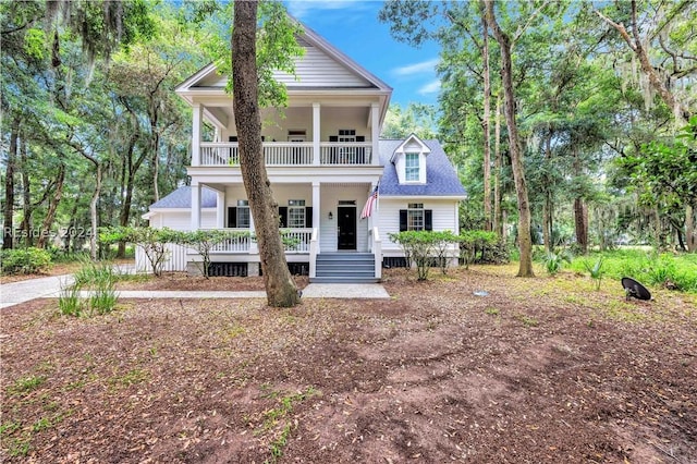 view of front of house with a balcony and covered porch