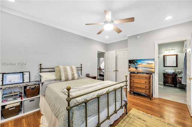 bedroom featuring crown molding, ceiling fan, and light hardwood / wood-style flooring