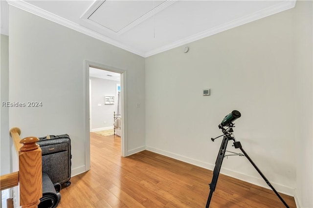 interior space featuring wood-type flooring and crown molding