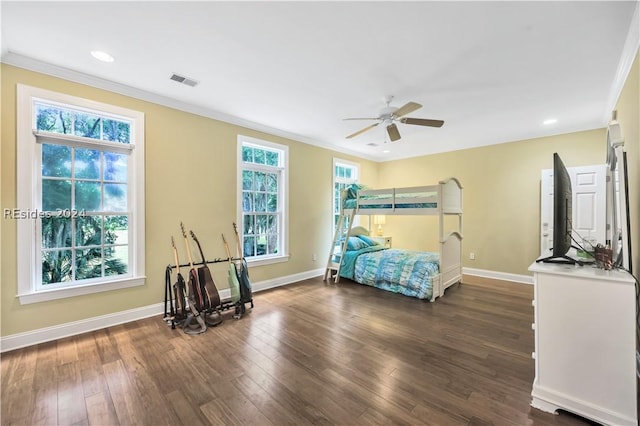 bedroom with dark hardwood / wood-style flooring, ornamental molding, and ceiling fan