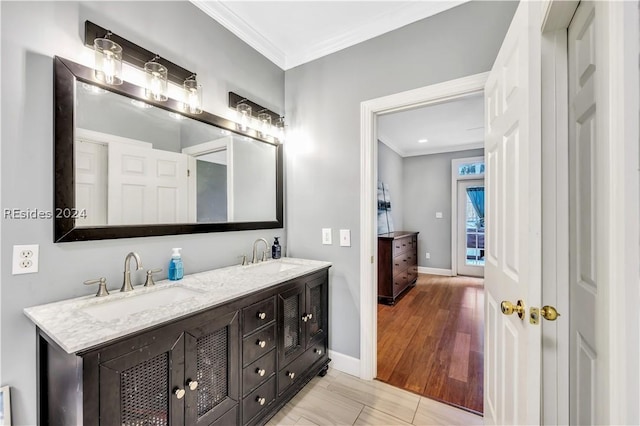 bathroom featuring tile patterned flooring, vanity, and ornamental molding