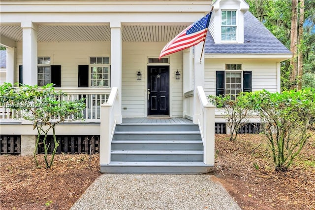 view of exterior entry with covered porch