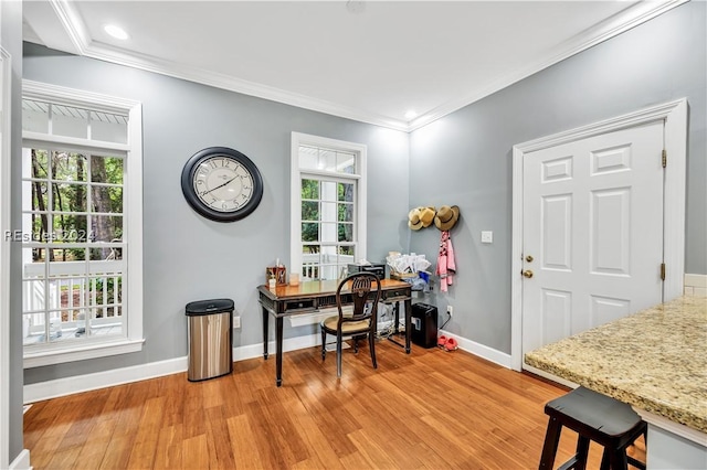 home office featuring light hardwood / wood-style flooring, ornamental molding, and a healthy amount of sunlight