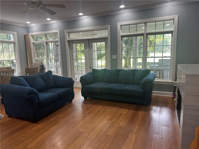 living room with french doors, a wealth of natural light, and hardwood / wood-style flooring