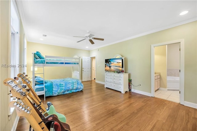 bedroom featuring ensuite bath, ornamental molding, ceiling fan, and light wood-type flooring