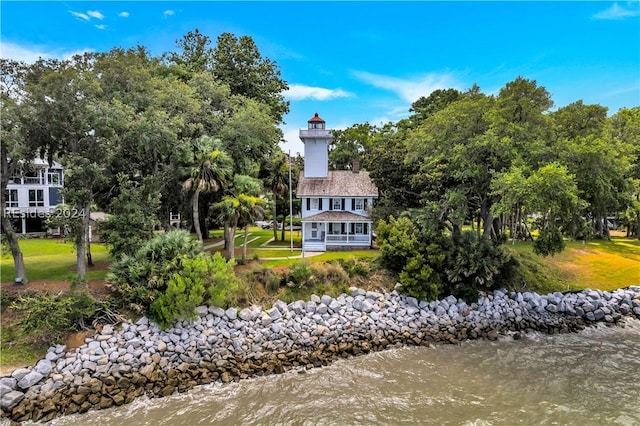 rear view of house featuring a water view