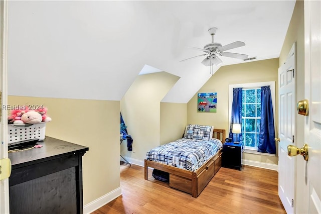 bedroom featuring lofted ceiling, wood-type flooring, and ceiling fan