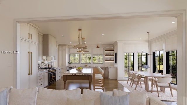 kitchen featuring pendant lighting, premium appliances, plenty of natural light, and a center island