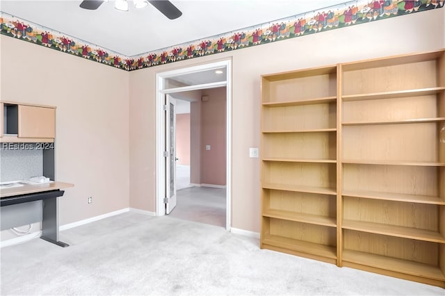 unfurnished living room with ceiling fan and carpet flooring