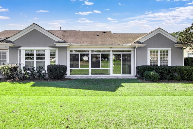 rear view of property featuring a yard