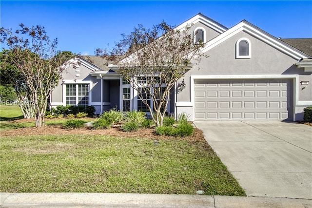 view of front facade featuring a garage and a front lawn