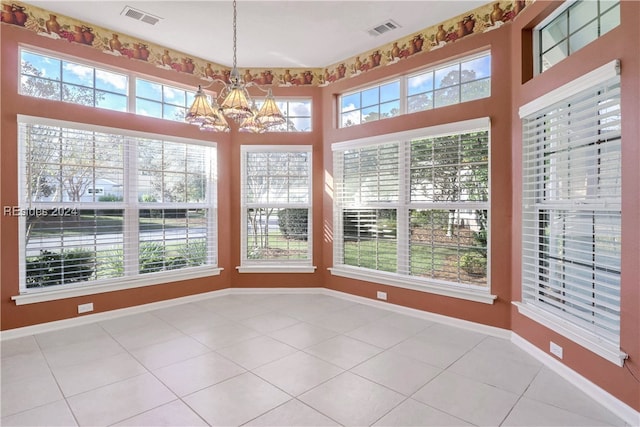 unfurnished sunroom featuring a notable chandelier