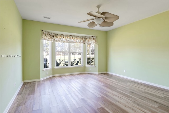 empty room featuring ceiling fan and light wood-type flooring