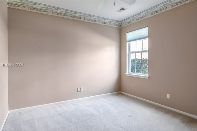 spare room with light colored carpet and ceiling fan