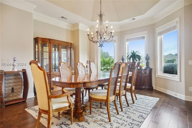 dining room featuring crown molding, dark hardwood / wood-style flooring, a raised ceiling, and a notable chandelier