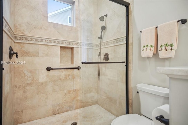 bathroom with toilet and an enclosed shower