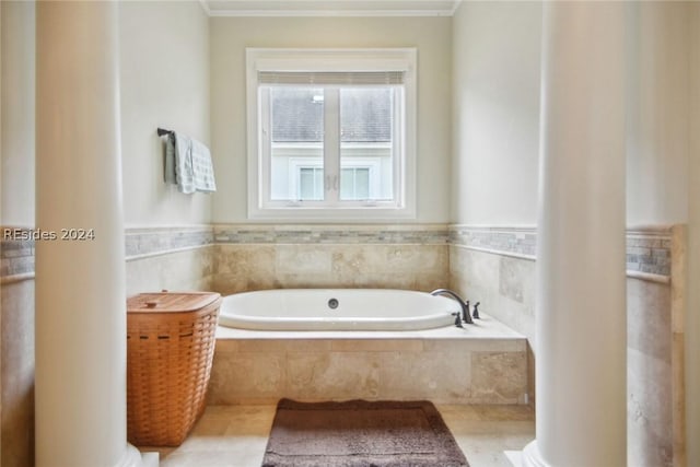 bathroom featuring crown molding and tiled tub