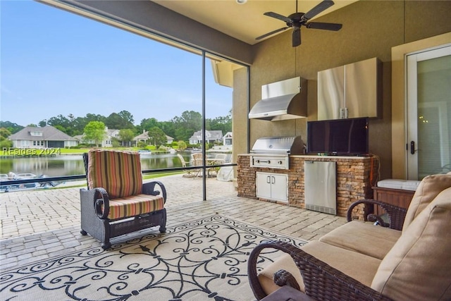 exterior space with a water view, area for grilling, and ceiling fan