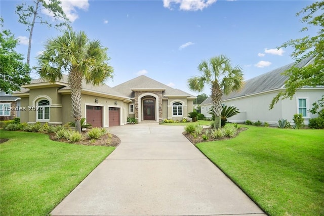 view of front of house featuring a garage and a front lawn