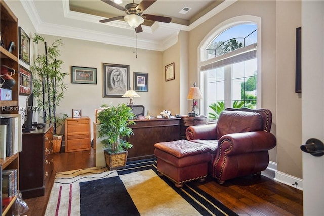 sitting room with crown molding, dark hardwood / wood-style floors, ceiling fan, and a tray ceiling