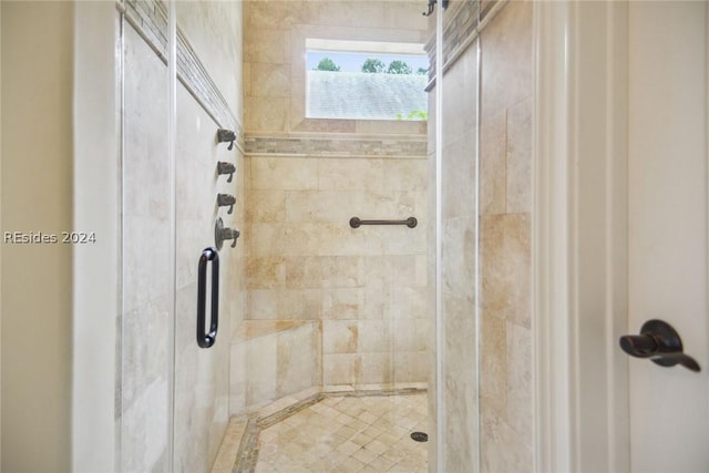 bathroom with a shower with shower door