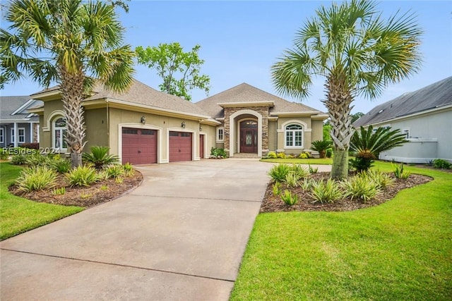 view of front of house with a garage and a front yard