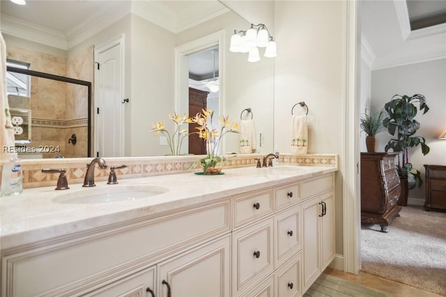 bathroom featuring an enclosed shower, vanity, and crown molding