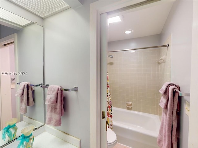 bathroom featuring toilet and shower / bath combo