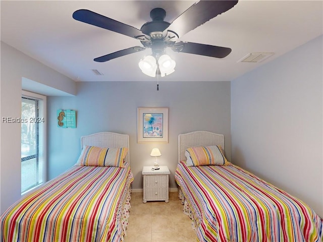 bedroom featuring light tile patterned floors and ceiling fan