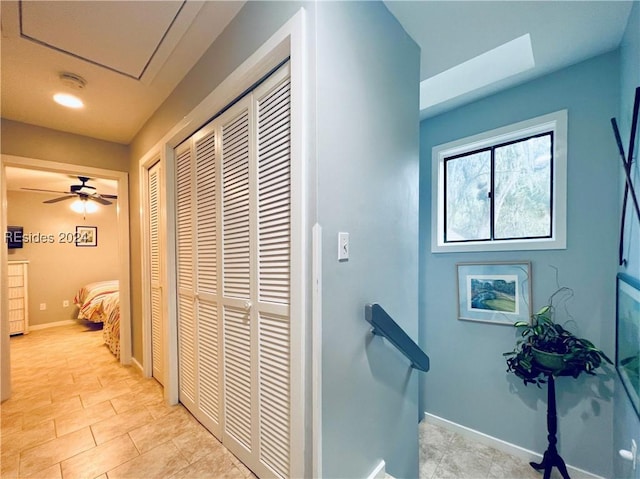 hall featuring light tile patterned flooring