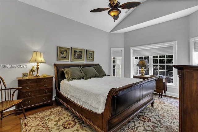 bedroom featuring ceiling fan, vaulted ceiling, and light hardwood / wood-style flooring