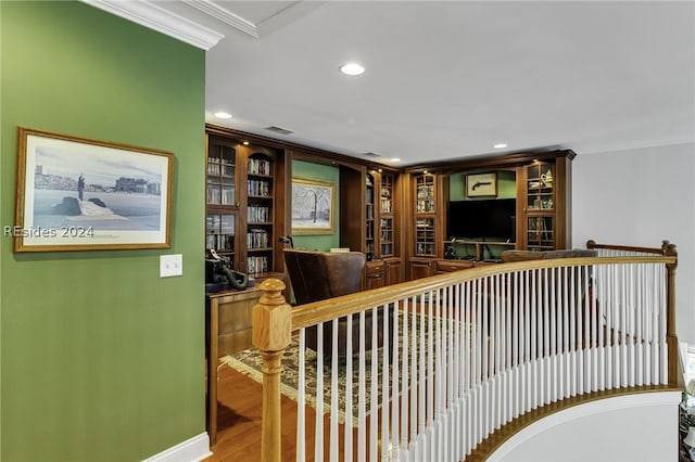 interior space with wood-type flooring and ornamental molding