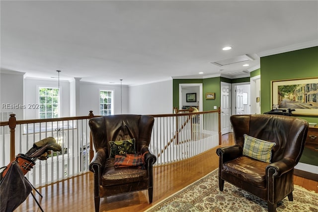 sitting room featuring light hardwood / wood-style flooring and ornamental molding