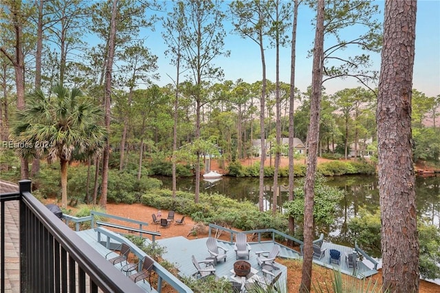 exterior space with a water view and a fire pit