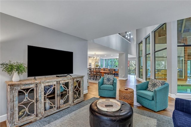 living room featuring an inviting chandelier and light hardwood / wood-style flooring