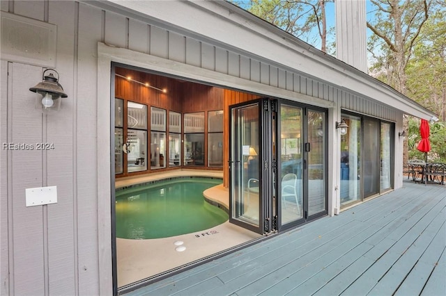 view of swimming pool with a wooden deck