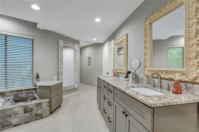 bathroom with vanity, a tub to relax in, and tile patterned flooring