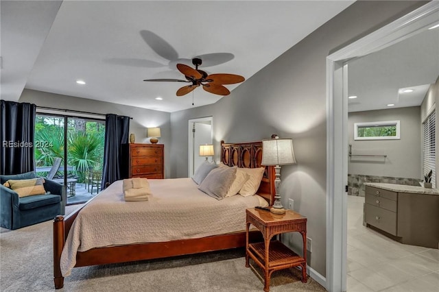 bedroom featuring ceiling fan, ensuite bathroom, access to exterior, and light carpet