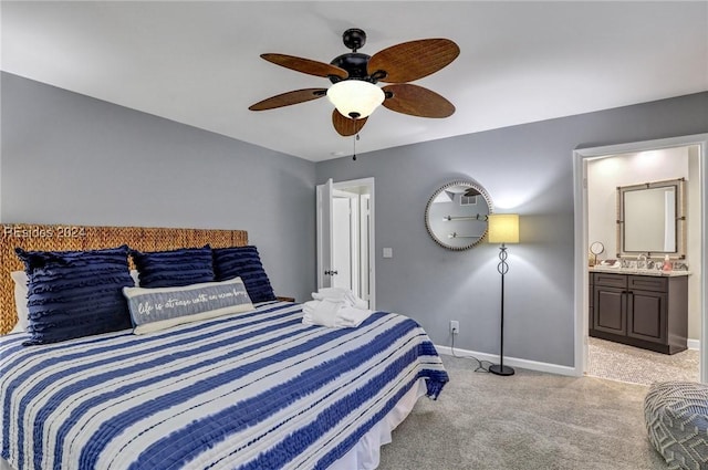 carpeted bedroom featuring ceiling fan, connected bathroom, and sink