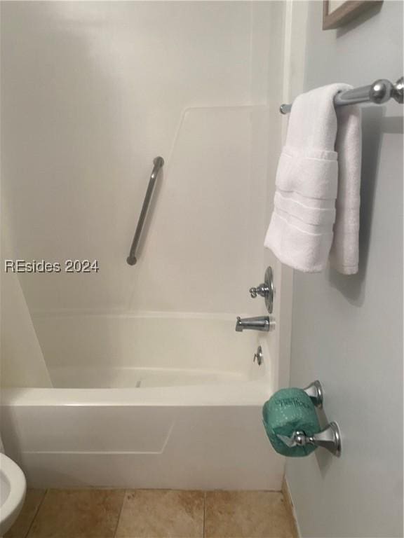 bathroom featuring tile patterned flooring and  shower combination