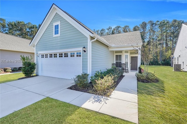 view of front of home with a garage, a porch, a front lawn, and central air condition unit