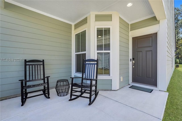 doorway to property featuring covered porch