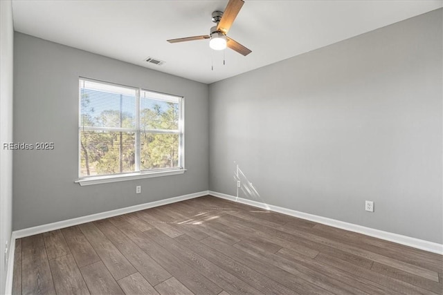 empty room featuring hardwood / wood-style flooring and ceiling fan