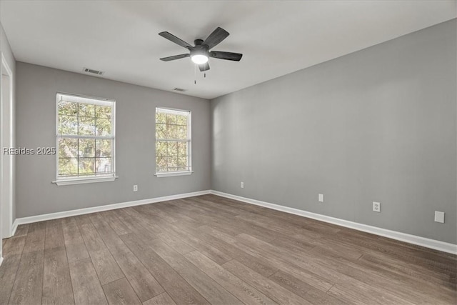 empty room featuring hardwood / wood-style flooring and ceiling fan