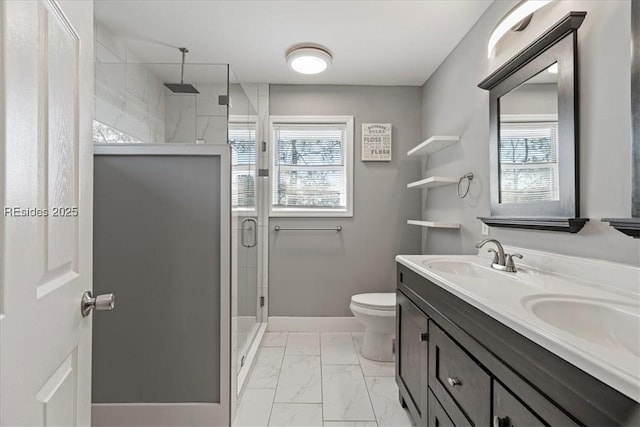 bathroom with plenty of natural light, toilet, a shower with shower door, and vanity